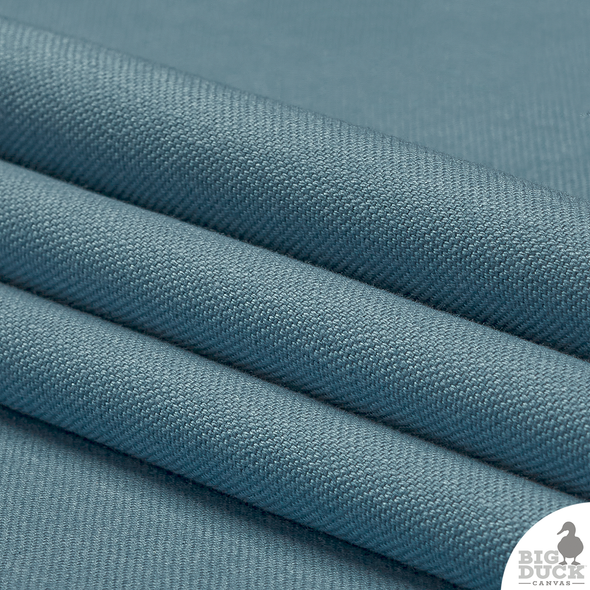 Folded yard of Smoke Blue cotton canvas — durable medium-weight fabric perfect for pillows and cornhole bags.